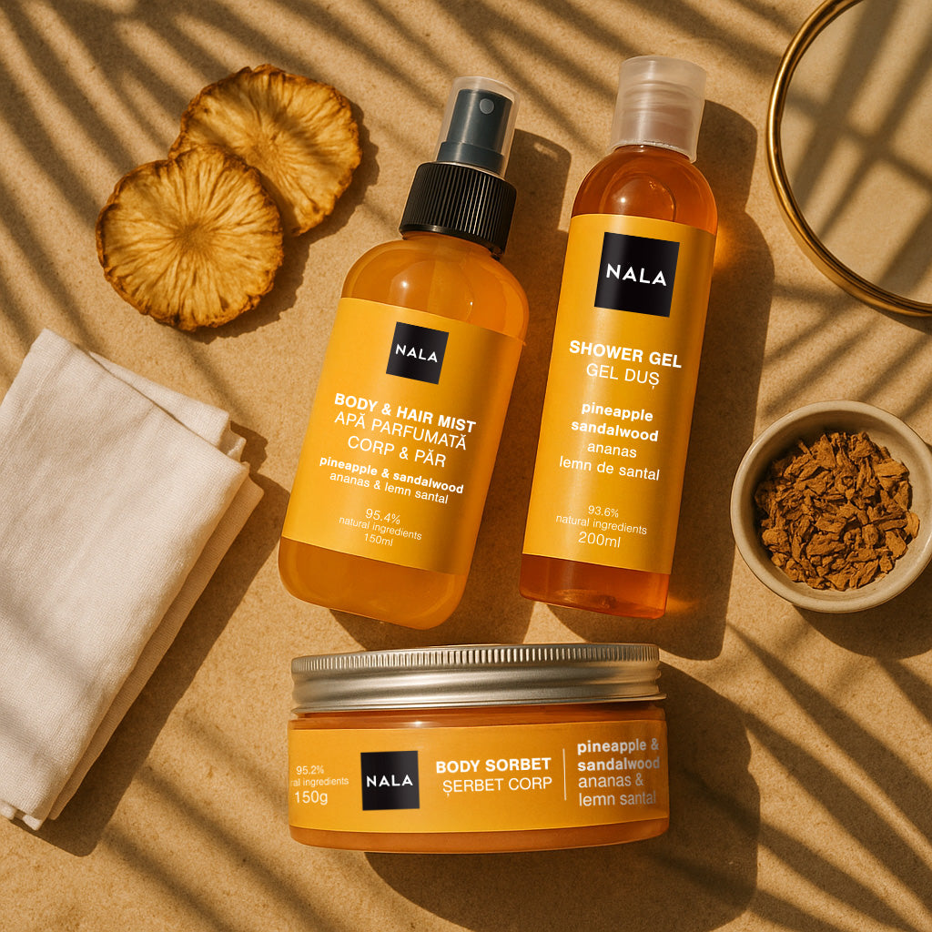 NALA skincare products including a body mist, shower gel, and body sorbet on a beige background with pineapple slices.