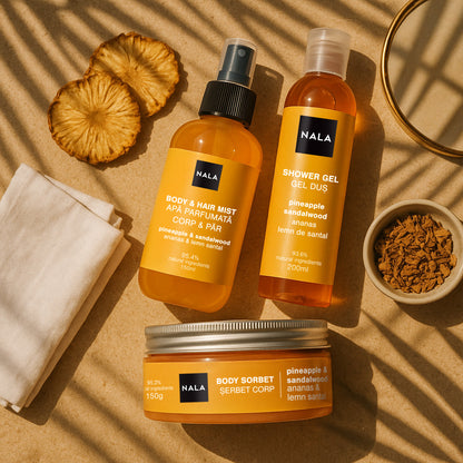 NALA skincare products including a body mist, shower gel, and body sorbet on a beige background with pineapple slices.